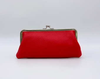 May include: A red leather coin purse with a silver clasp.