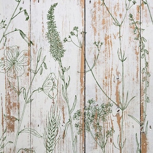 May include: A close-up of a white wooden surface with a distressed finish, featuring a repeating pattern of green botanical line drawings. The design includes various flowers, leaves, and stems, creating a natural, rustic aesthetic.