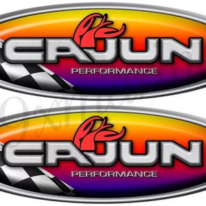 May include: Two oval-shaped stickers with a silver border. The stickers feature the word "CAJUN" in silver, with "PERFORMANCE" below. A red design and a checkered flag are also present, set against a gradient background.
