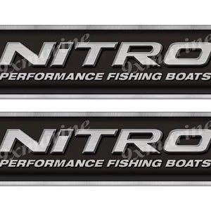 May include: Two rectangular black and silver metal signs with the word "NITRO" in large, metallic, capital letters. Below, the text reads "PERFORMANCE FISHING BOATS". The signs have a silver border and are secured with four silver rivets.
