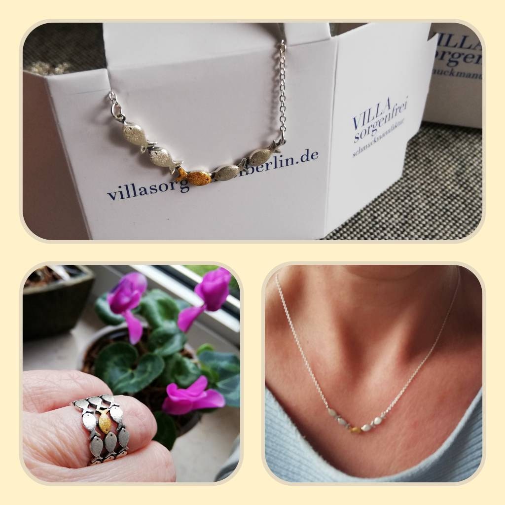 Swimming against the current. Dainty silver necklace. School of fish with one golden enameled fish swimming upstream. Gift for her.