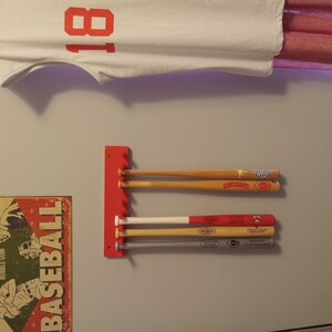 thumbnail interactive-video image 1 of Baseball Bat Rack Holds 17 Mini Bats & 6 Balls Wall Display Holder Trophy Awards 1 of 2