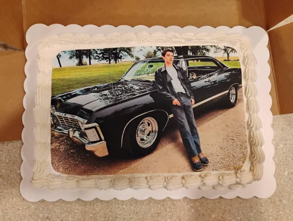 Customer's finished cake with custom edible topper