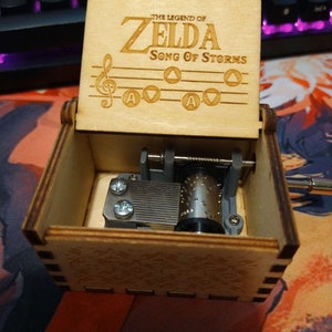  The Legend of Zelda Music Box Hand Crank Musical Box Carved  Wooden,Play Zelda:Song of Storms from Ocarina of Time,Brown : Home & Kitchen