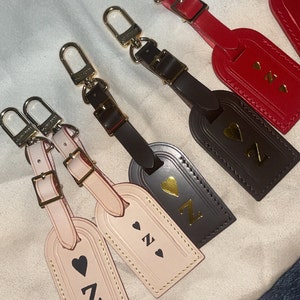 HAVE: Dark Brown Louis Vuitton Luggage Tag :) love the red hot stamp!!