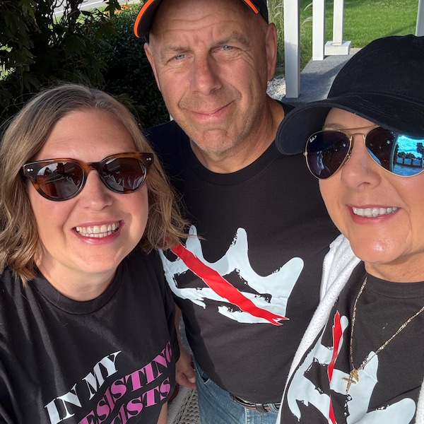 Person wearing a NO KINGS protest tee in bold block text