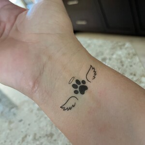 Lines N Shades Tattoo Studio  Dogs are said to be mans bestfriend And  here is an adorable paw tattoo with angel wings and we cant get over how  lovely it looks