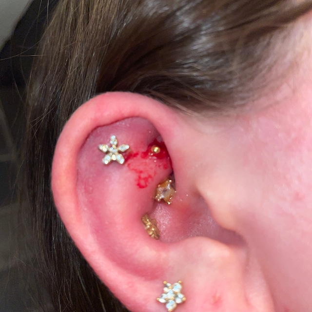 Helix piercing: pain, healing, jewelry - obsidian piercing