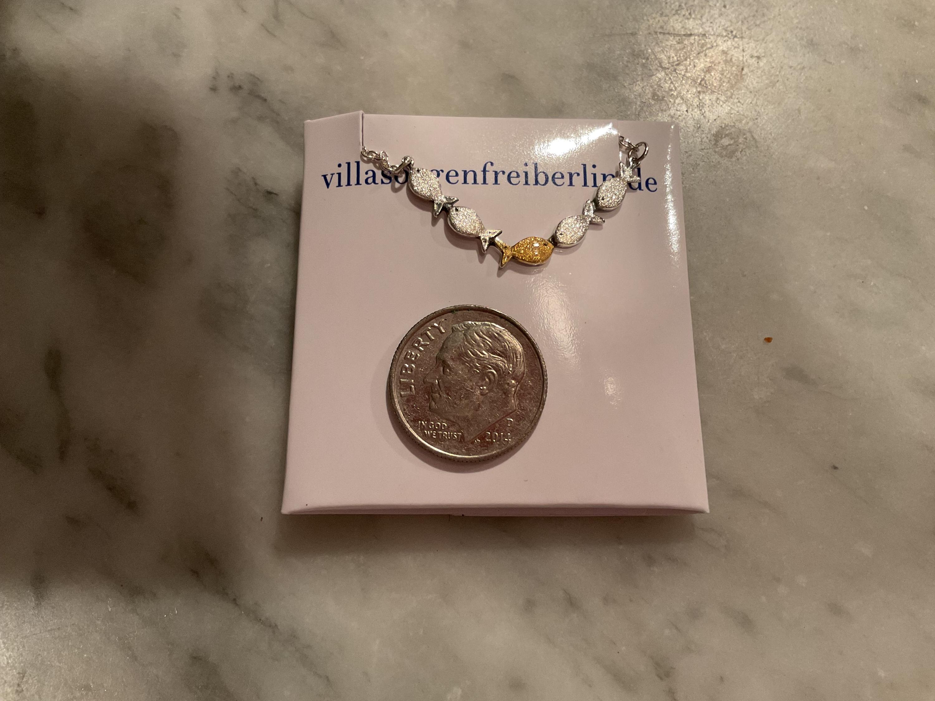 Swimming against the current. Dainty silver necklace. School of fish with one golden enameled fish swimming upstream. Gift for her.