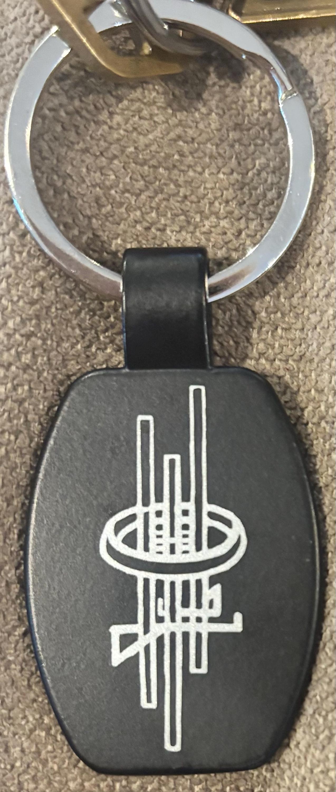 Customer photo of Custom Logo Etched Black Metal Keychains from Cheryl