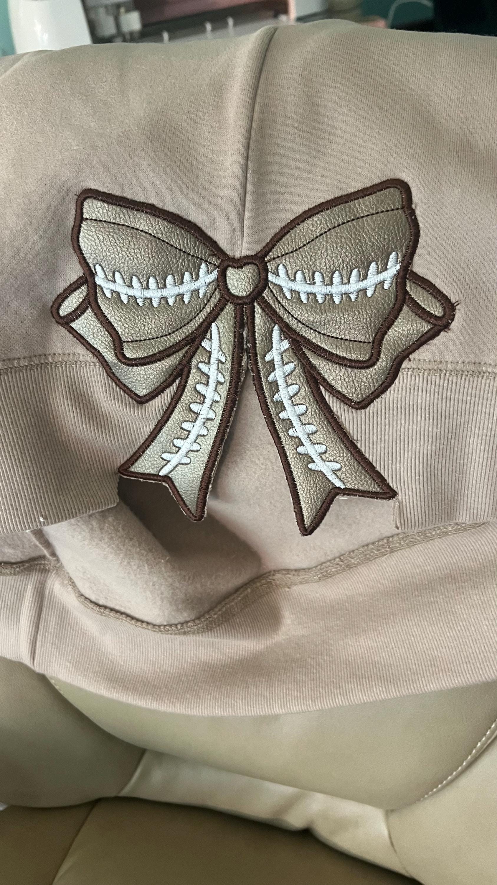 Customer project using Football Stitch Bow and Heart Applique embroidery design