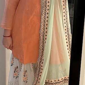 Mustard yellow draped skirt with  jamawar jacket and green blouse