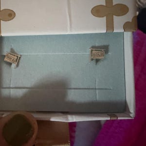 Customer photo, SOLD Sign Stud Earrings