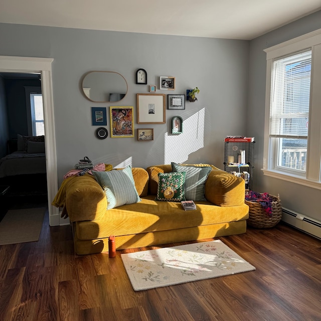 Mustard yellow sofa on a dark wooden floor in a living room with a picture wall, photographed by the buyer