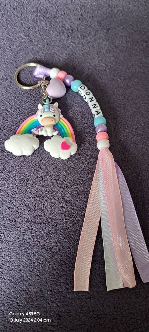 Colourful Handmade Personalised Keyring with a Cute Large Pony Sitting on a Rainbow with Heart Charm