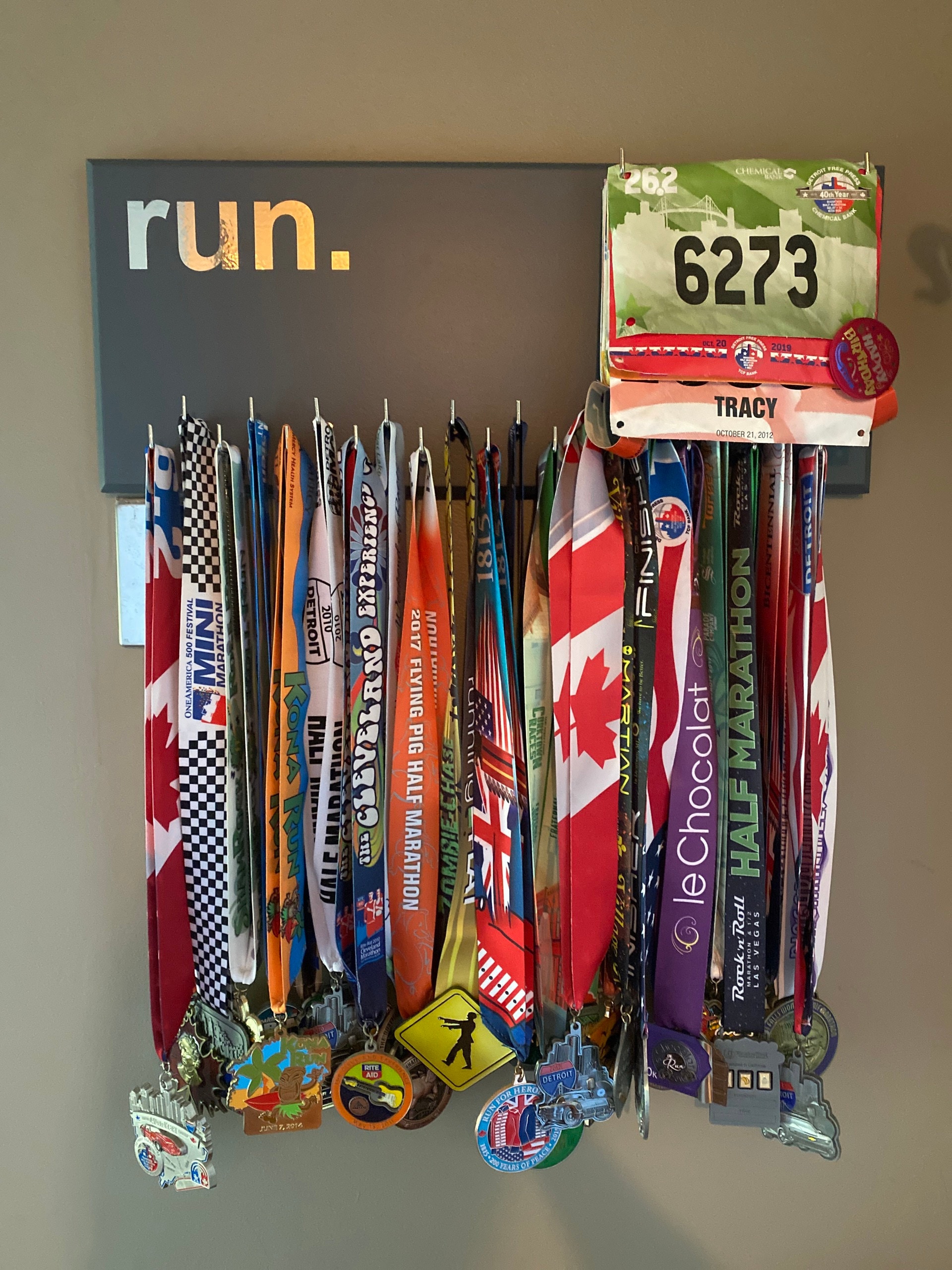 Running Medal Holder, gray or black with chrome "run." vinyl, 21 hooks and BIB holder