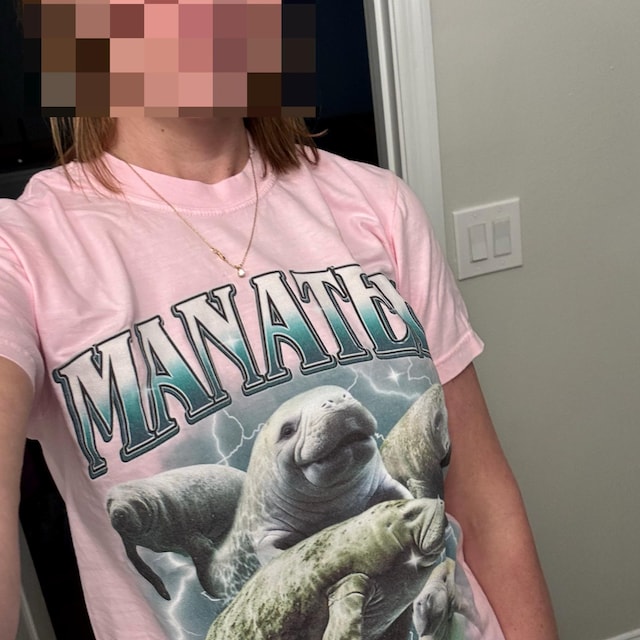 Customer wearing printed graphic tee, laughing