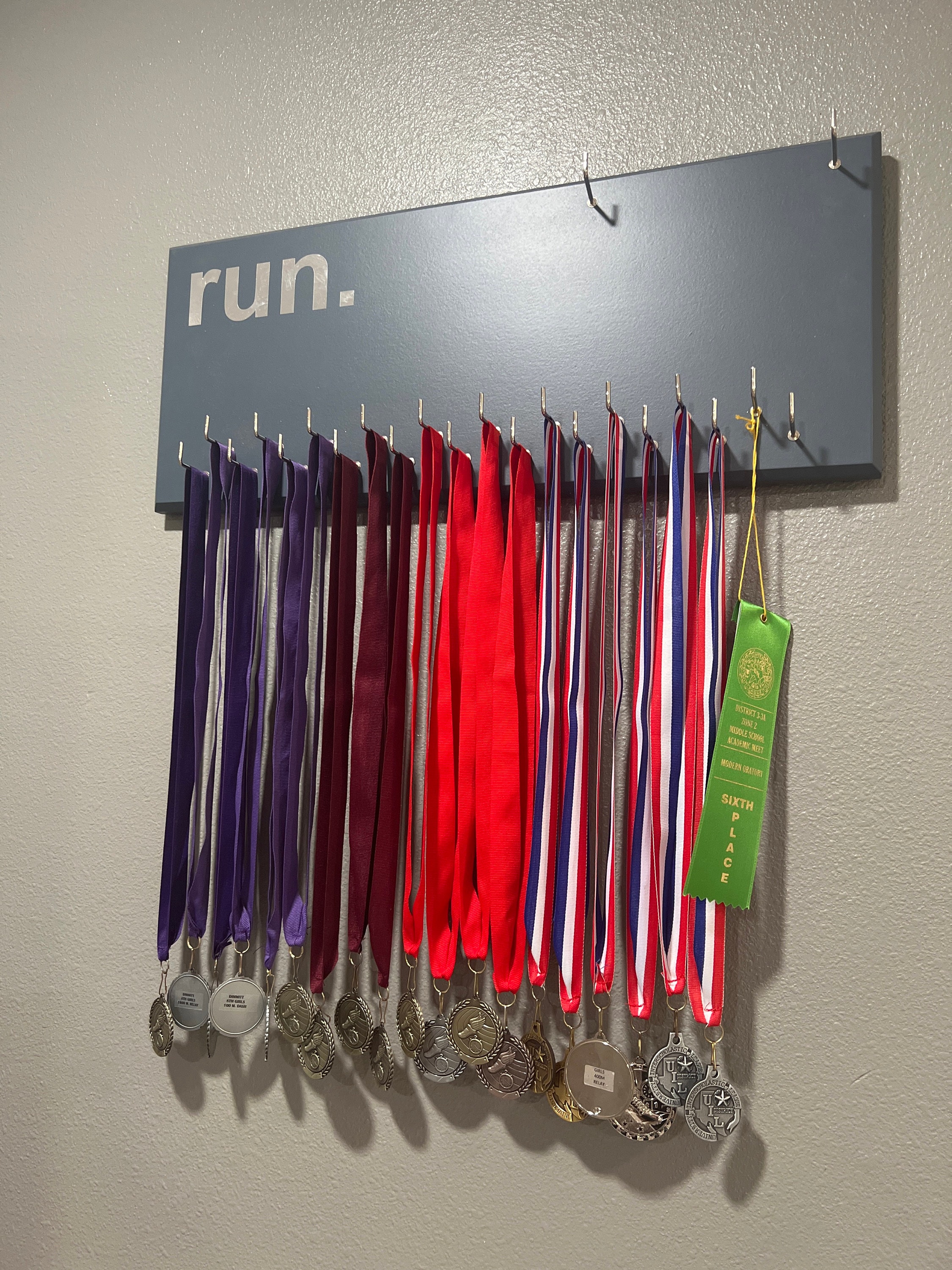 Running Medal Holder, gray or black with chrome "run." vinyl, 21 hooks and BIB holder