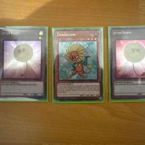 dandelion yugioh card DUSA-DE059 - Lion - Ultra Rare - German - in Set with Ultrapro Toploader TypePlant / Effect Monster AttributeEARTH Level / Rank3 ATK / DEF300 / 300 Card TextIf this card is sent from the hand or field to the GY Both have been banned for