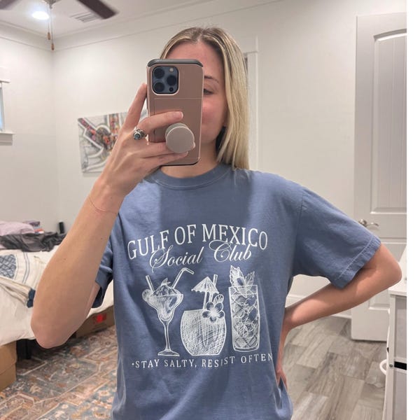 Mirror selfie wearing aesthetic graphic tee