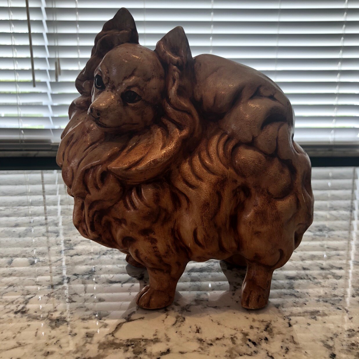 pomeranian statue with wings