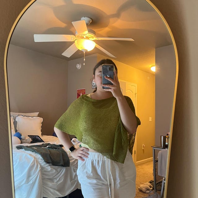 Sally wearing the moss green Prema Poncho