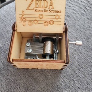  The Legend of Zelda Music Box Hand Crank Musical Box Carved  Wooden,Play Zelda:Song of Storms from Ocarina of Time,Brown : Home & Kitchen