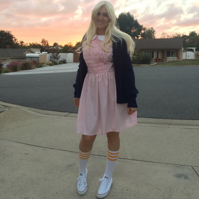 eleven wearing pink dress How Eleven finds her identity through style in Season 3 of Stranger Things