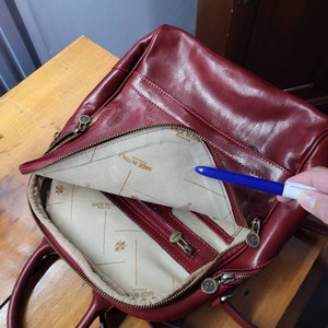 Refinished the leather on my vintage Louis Vuitton Alma bag and hand  painted it with a red-pink that I am in LOVE with. Covered all the stains  and scuffs and looks brand