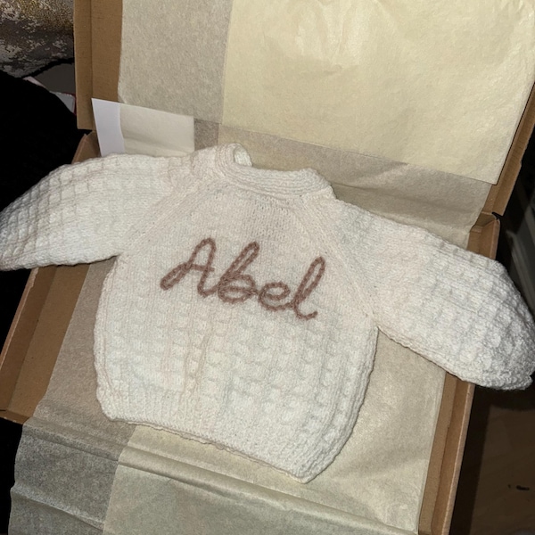 Personalised baby cardigan hand knitted for newborn baby hand