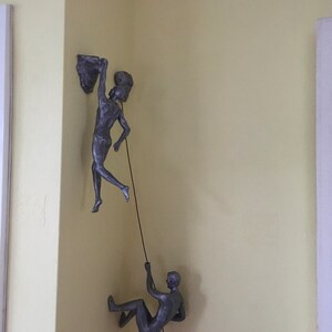 bronze abseiling figures