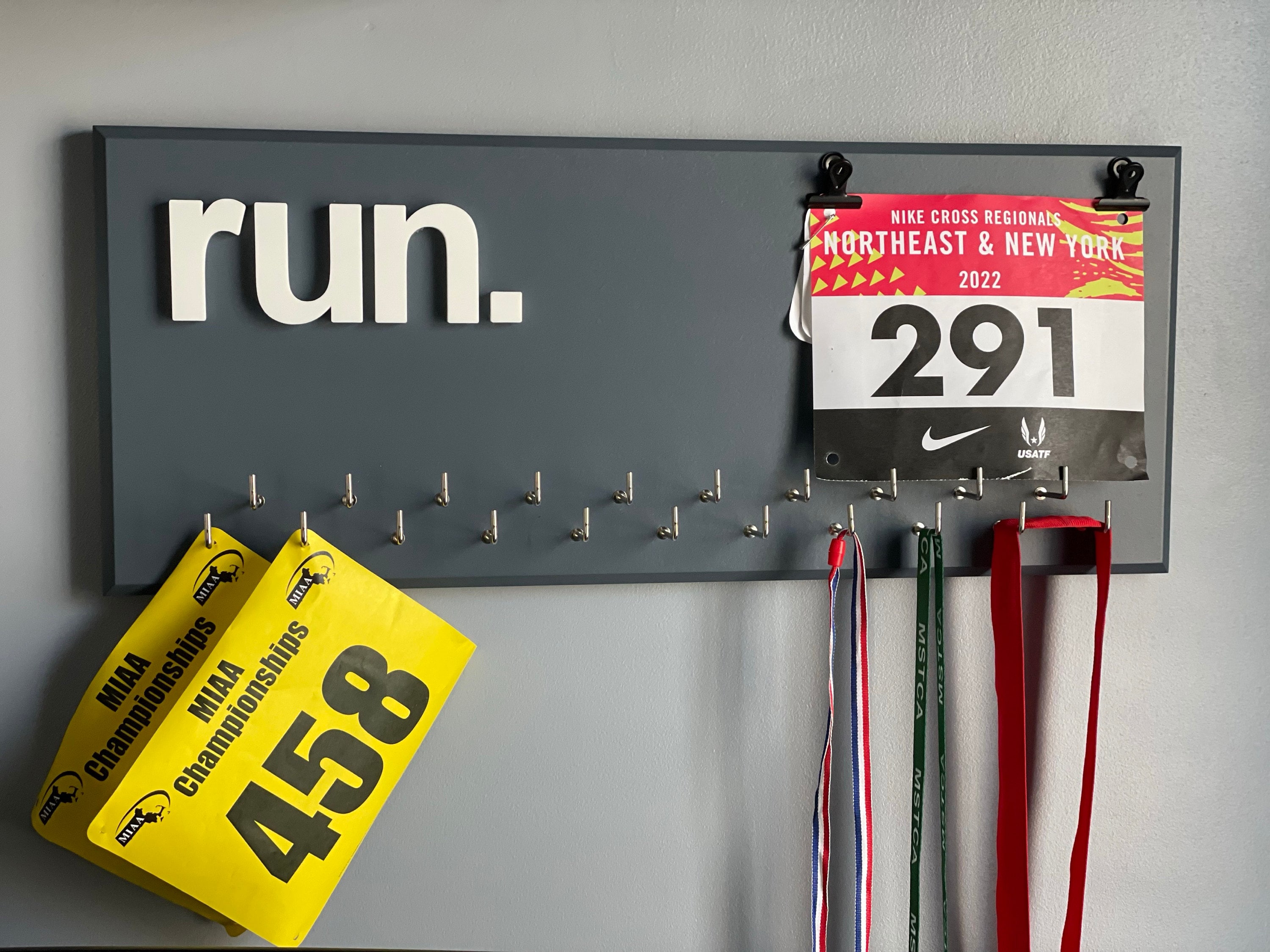 Running Medal Holder, gray or black with chrome "run." vinyl, 21 hooks and BIB holder