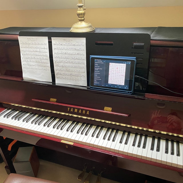 Music stand outlet for upright piano