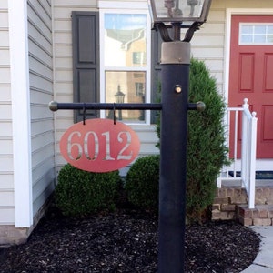 white lamp post with address sign
