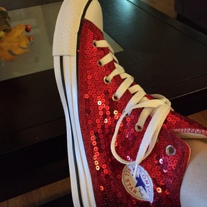 red sparkly converse high tops