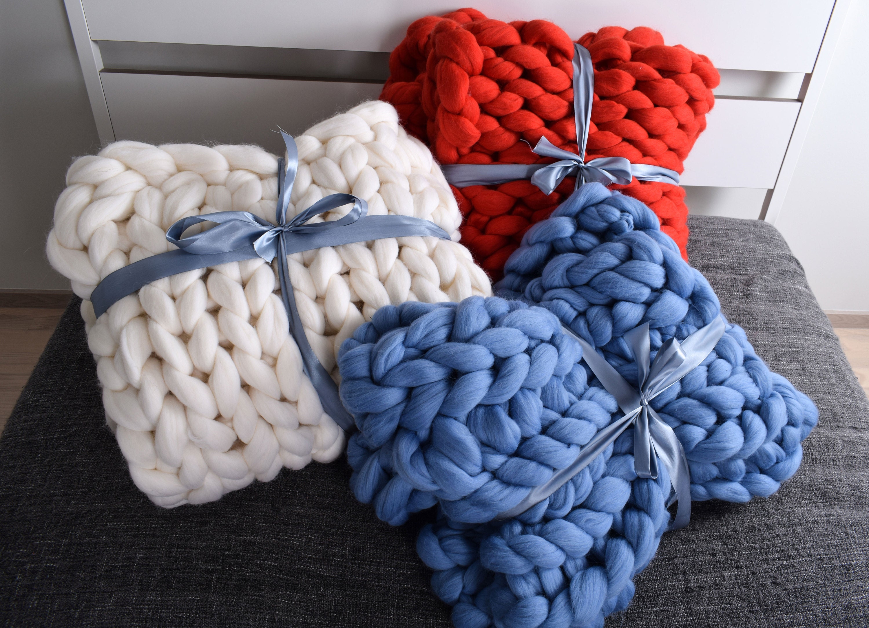 Knitted and Folded Chunky Blanket with Knitting Needles, Yarn Ball in Human  Hands on Neutral Background Stock Image - Image of craftsmanship, craft:  208859619