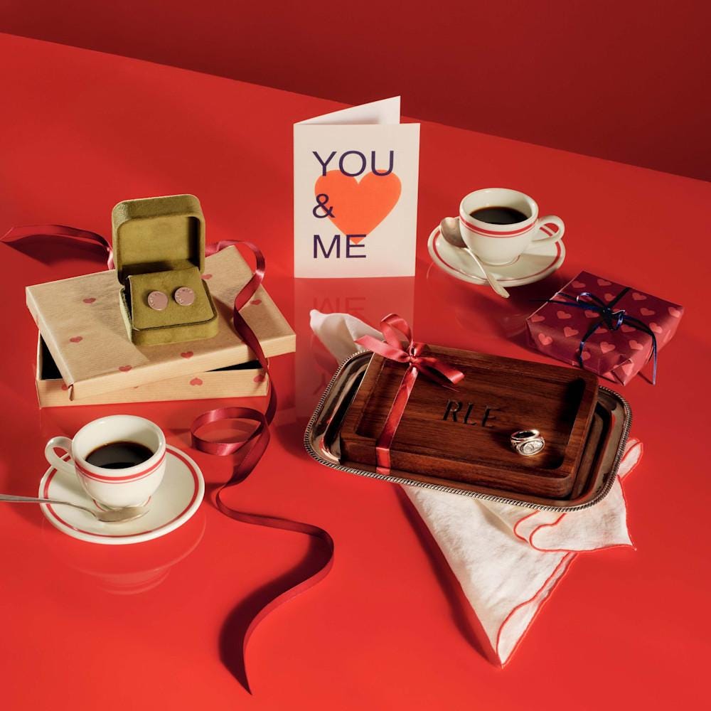 Collection of Valentines gifts for men including a valentines card, wooden tray, coffee cup, and cufflinks