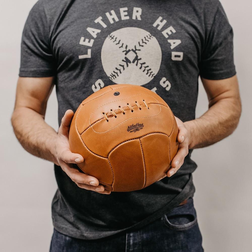 Man holding a leather football ball