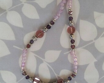 Dramatic pink beaded necklace with mauve and violet accents