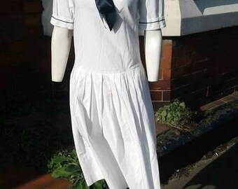 Beautiful iconic 1980s white and navy nautical sailor dress made by Laura Ashley in cotton with big navy ribbon bow