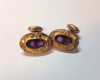 Cufflinks with purple rhinestone.
