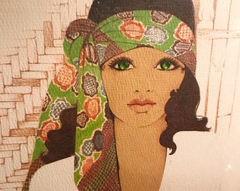 Vintage framed artwork of glamorous lady with green eyes and tan skin.
