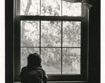Boy at the window.Silver gelatin print