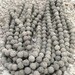 6mm Gray Lava Beads, Rough, round shape lava stone with straight drill. Approx stone size 6-6.5mm Diameter.1 strand - 62-65 beads -.