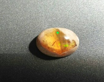 Mexican Fire Opal in Matrix oval Cabochon -- 10.5 mm x 15 mm