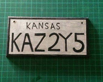Impala license plate , Sam Winchester , Dean Winchester , Supernatural .