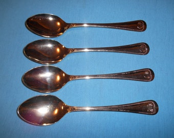 Four (4). Gold-Electroplated, 7 1/2" Place / Oval Soup Spoons, from Supreme Cutlery, by Towle, in the Abbey Shell Pattern.
