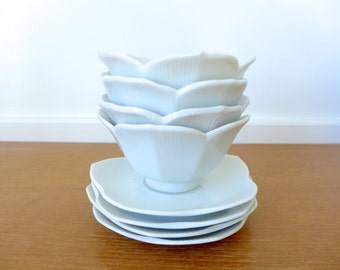 Four white lotus bowls with matching saucers