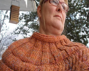 Shoulder warmer with cables.