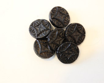 Eleven black glass vintage buttons.